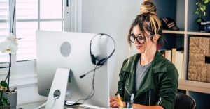 woman working at desktop computer | Short-Form Vs Long-Form Content for Your Business